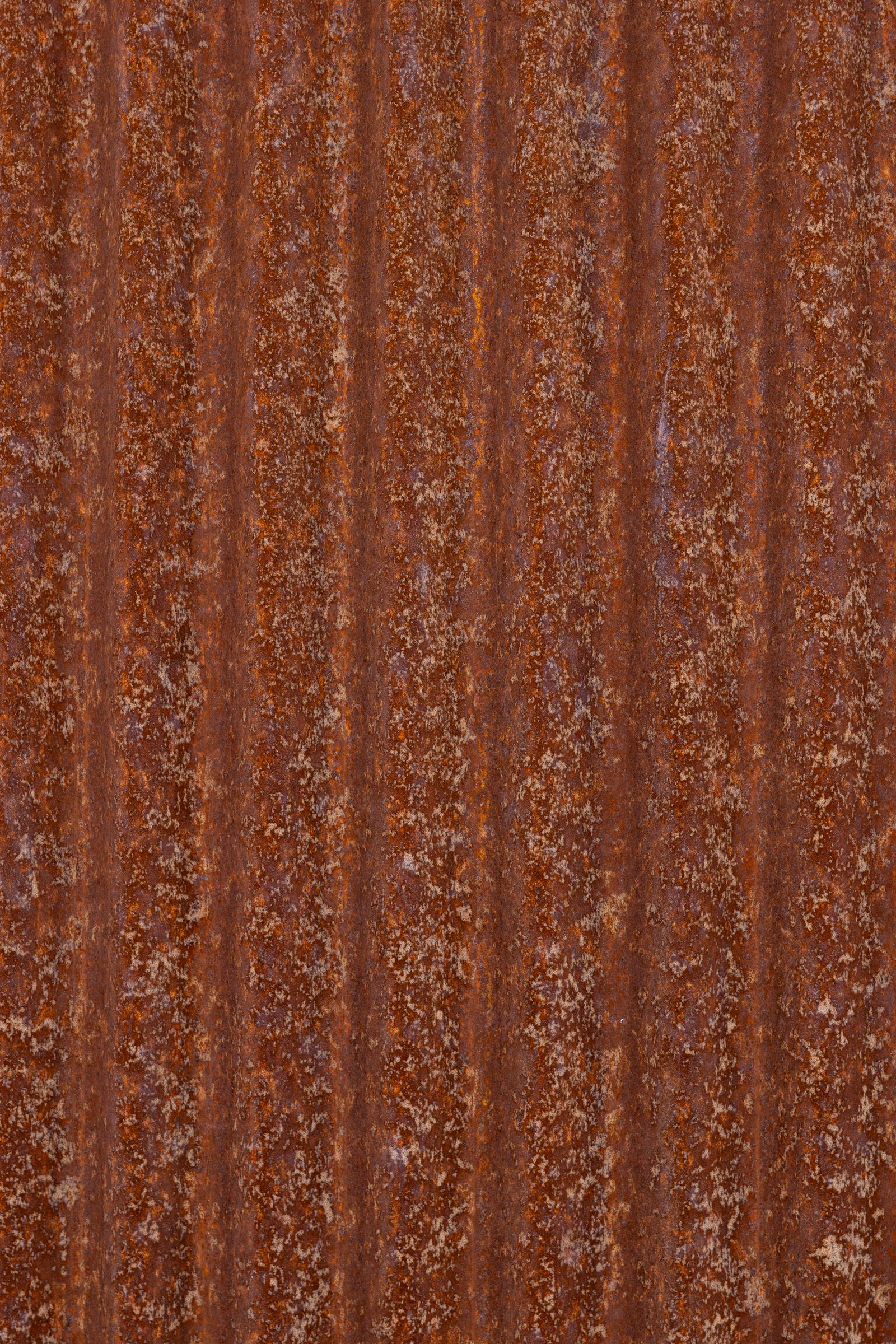 Close-up of a corrugated steel fence panel showing the ribbed profile
